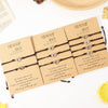 Three sets of black cord friendship bracelets with silver heart charms on kraft paper cards