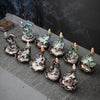 Ceramic backflow incense burners with blue and brown glazes showing smoke flowing over koi fish