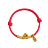 Close up of a red braided bracelet with a small gold horse charm and coin pendant