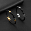 Two black beaded bracelets with metal clasps resting on dark textured surface