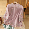 Pink cotton linen shirt with floral embroidery and stand collar on a wooden hanger