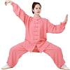 Model wearing a pink linen Tai Chi suit in a wide stance pose