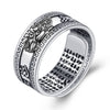 Close up view of a silver Pixiu ring with mantra engravings on the inside