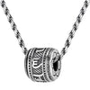 Close up of silver tone rotatable barrel pendant with mantra script on a twisted chain