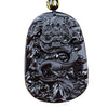 Close-up of a black glass dragon pendant necklace with intricate carving details