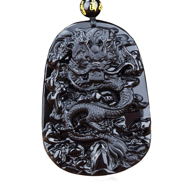 Close-up of a black glass dragon pendant necklace with intricate carving details