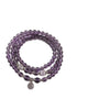 Three wrap amethyst bead bracelet with silver tone charm on white background