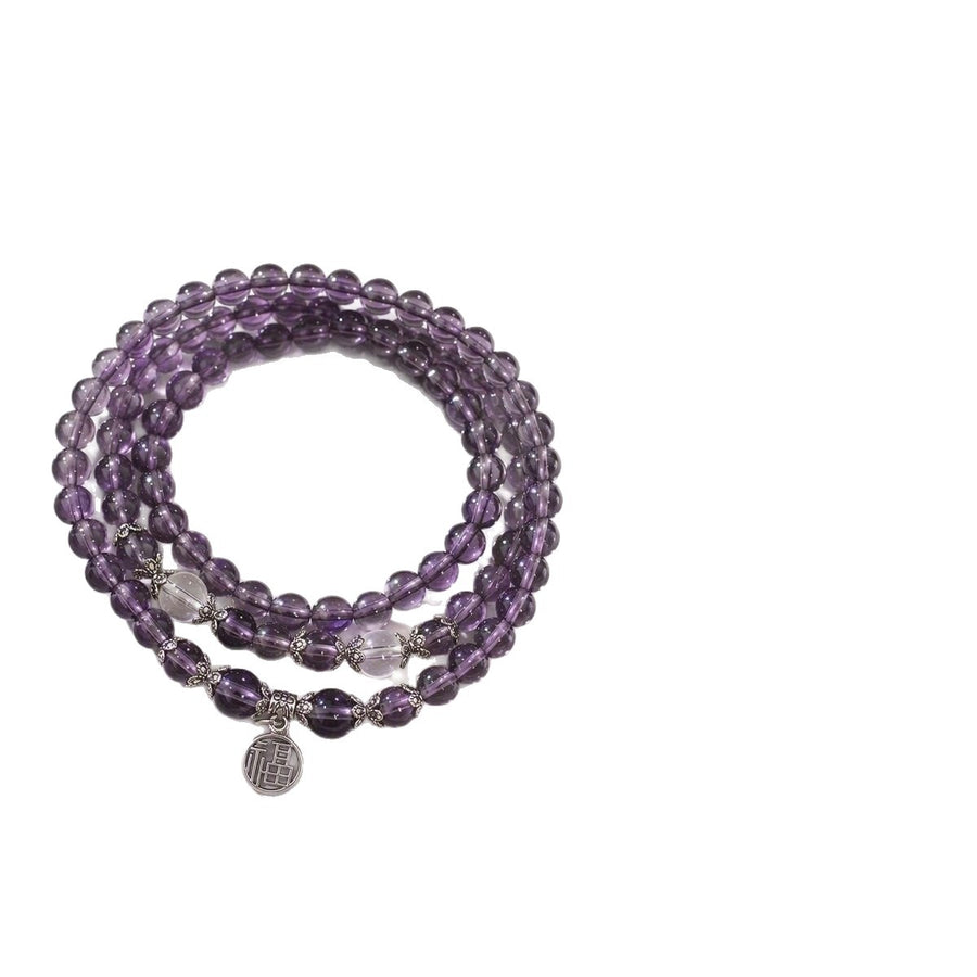 Three wrap amethyst bead bracelet with silver tone charm on white background