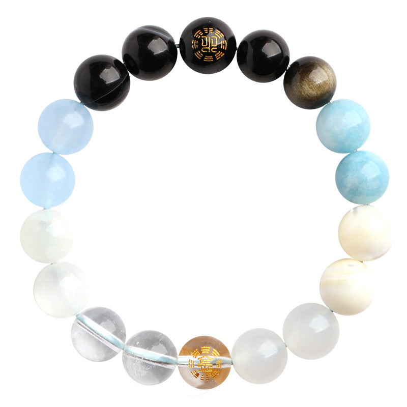 A beaded bracelet featuring black, blue, white and brown natural stones with gold pattern accents