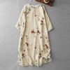 Flat lay of a beige linen dress with red floral print and frog buttons
