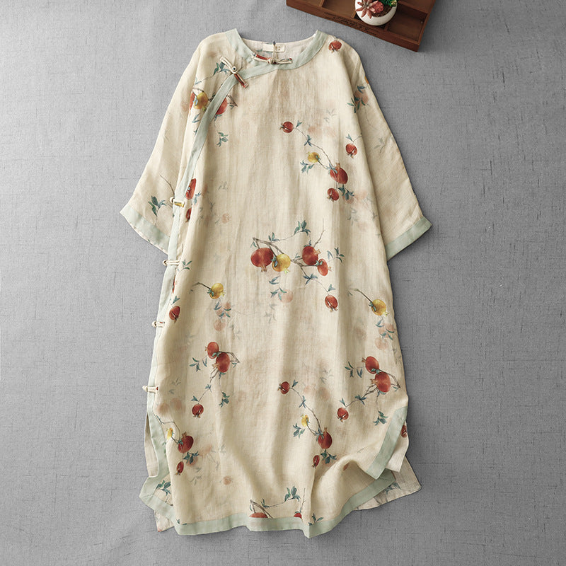 Flat lay of a beige linen dress with red floral print and frog buttons