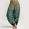 Model wearing green printed wide leg harem pants with white flowers