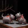 Two purple clay cat tea pets sitting on a tea tray
