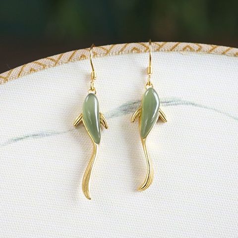 Gold tone dangle earrings shaped like koi fish with pale green bodies