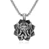 Close up of a silver tone stainless steel pendant showing an elephant head design on a dark blue background