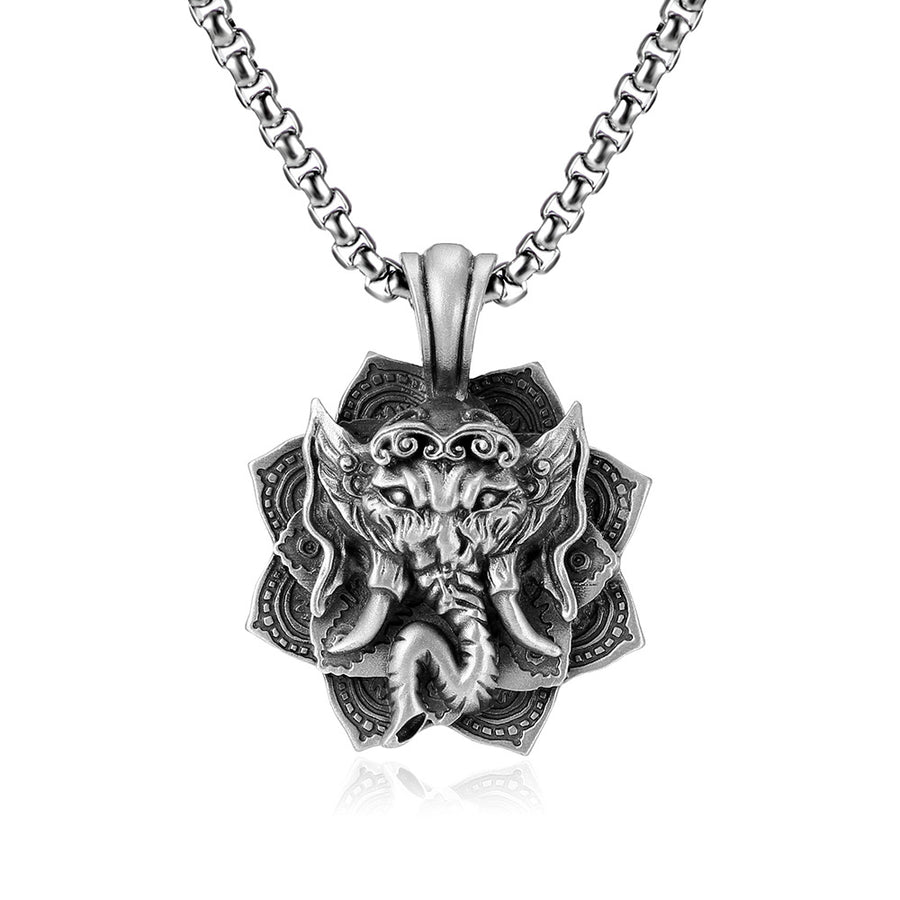 Close up of a silver tone stainless steel pendant showing an elephant head design on a dark blue background