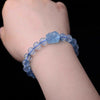 Close up of a light blue aquamarine beaded bracelet with a Pixiu charm on a wrist