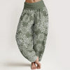Model wearing green floral print harem pants with elastic waist