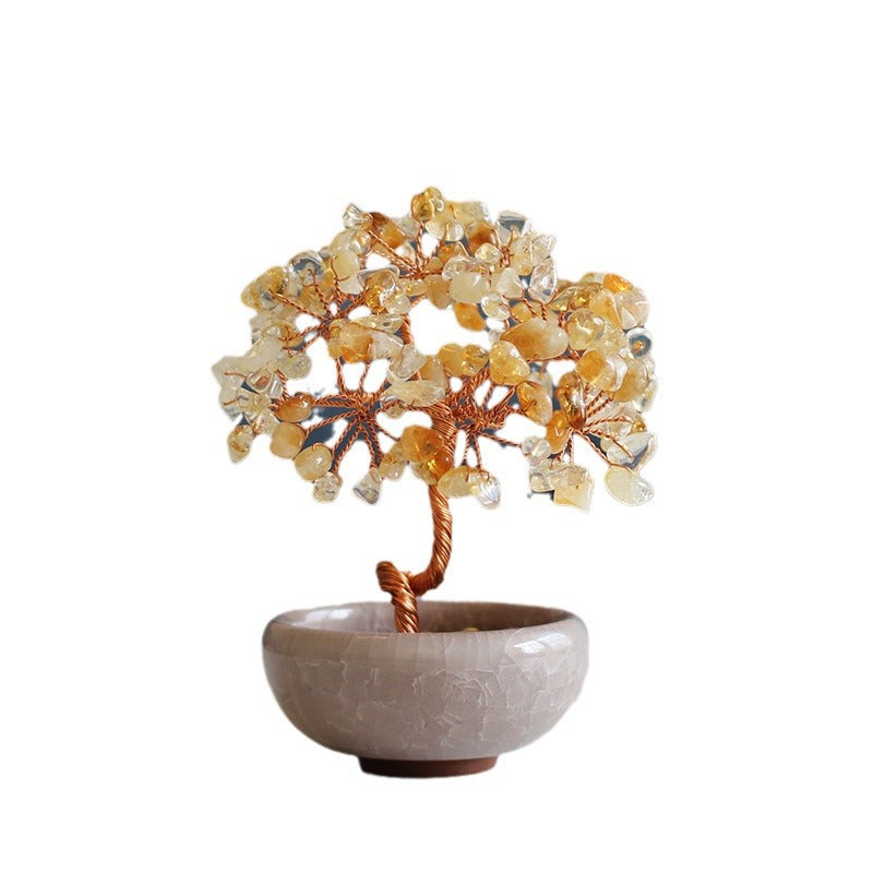 Wire tree sculpture with yellow and clear crystal stones in a small bowl