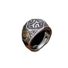 Close up of a vintage sterling silver ring with Sanskrit text on a dark background