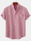 A pink men's linen short sleeve shirt with a collar and buttons