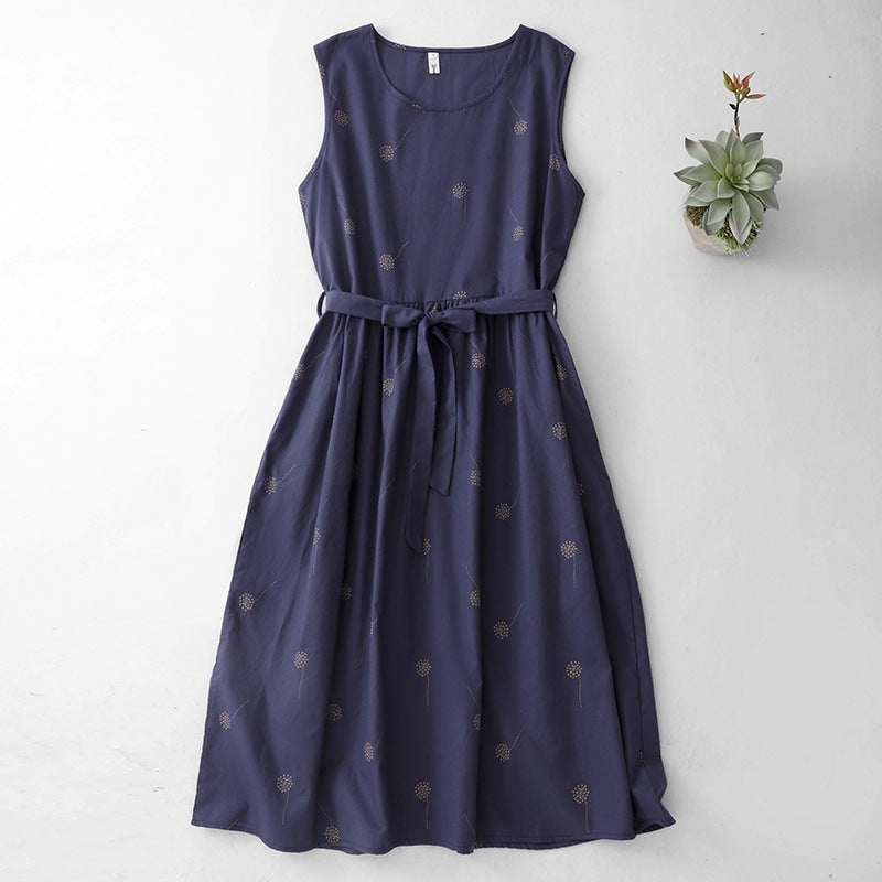 Flat lay of a navy blue sleeveless midi dress with small gold prints and a waist tie