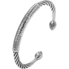 Silver tone open cuff bracelet with Tibetan script and twisted wire ends worn on wrist