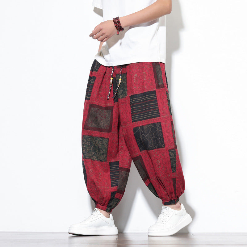 Model wearing red geometric print cotton harem pants with white sneakers