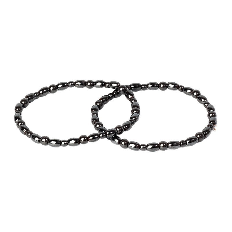 Two black natural hematite bead bracelets lying on a white background