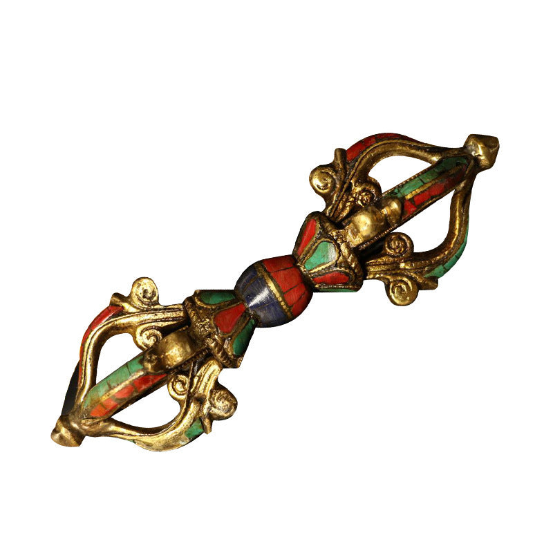 A handcrafted copper vajra dorje with colorful enamel details on a white background.