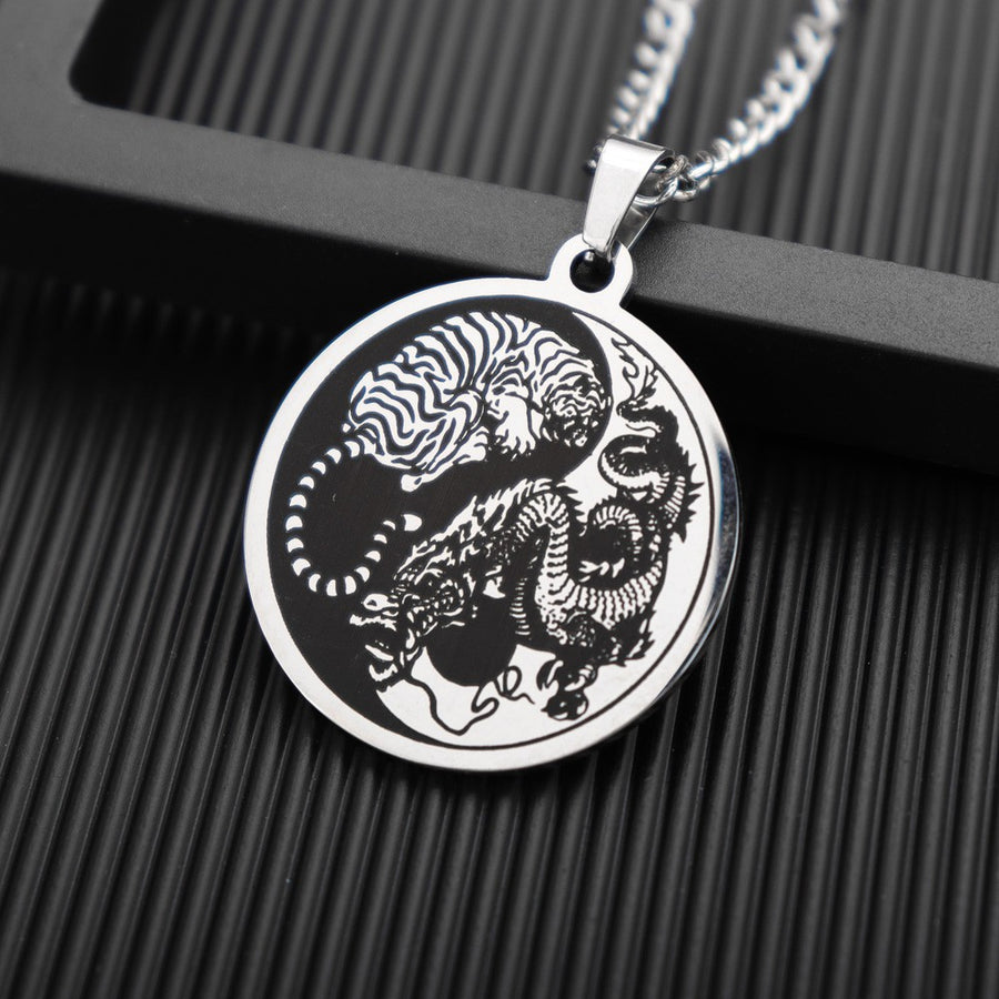 Silver-tone round pendant with engraved tiger and dragon design on a chain