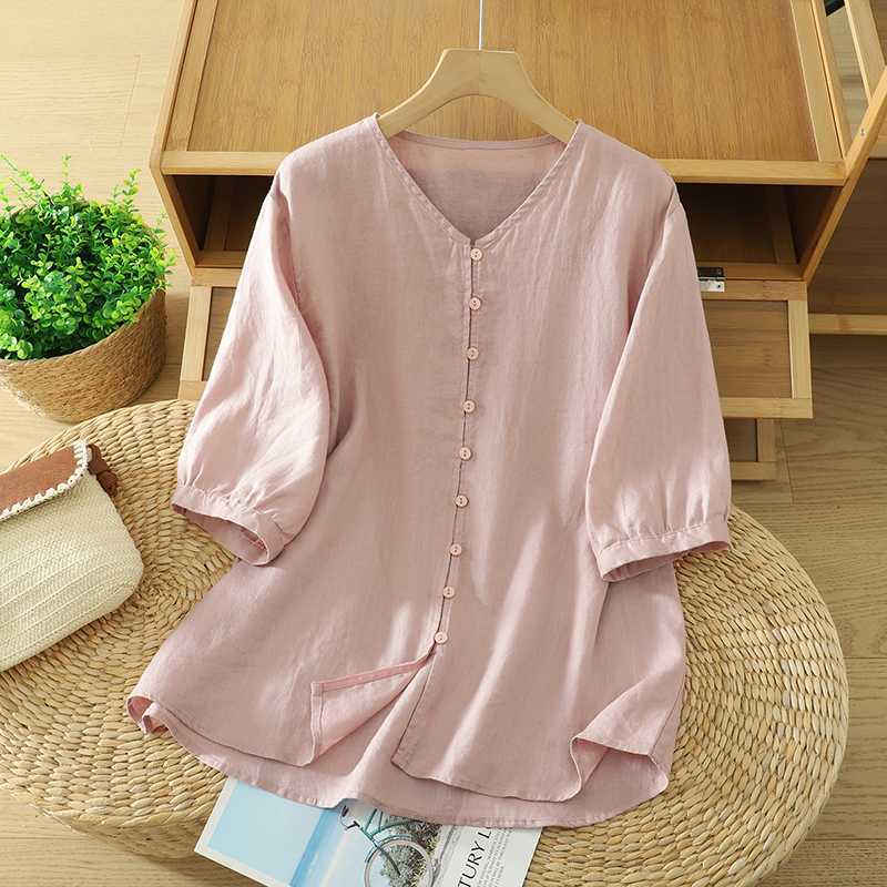 Pink cotton linen women's shirt with half sleeves and button front on a hanger