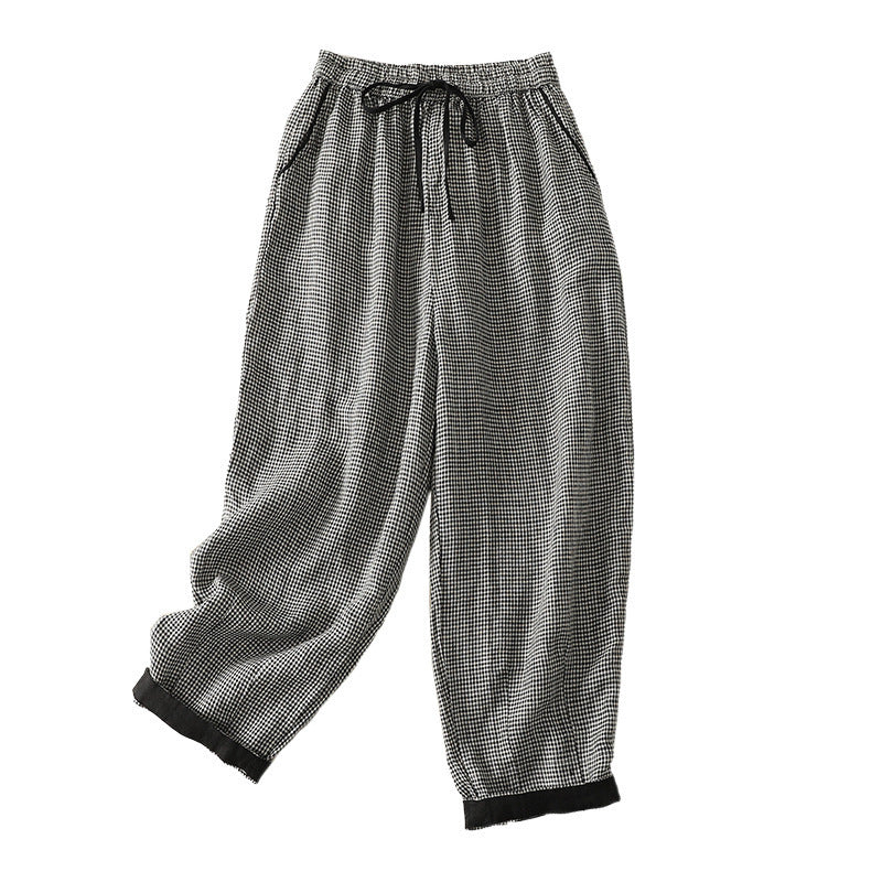Full view of black and white plaid women's harem pants with elastic waist