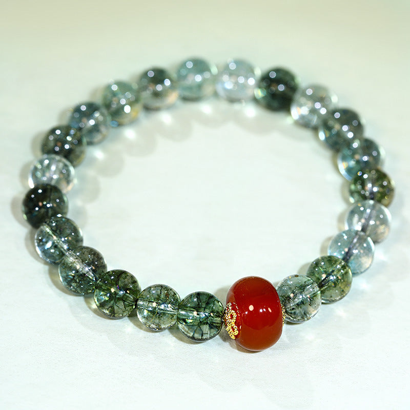 Beaded bracelet with green synthetic crystal and a single red agate bead