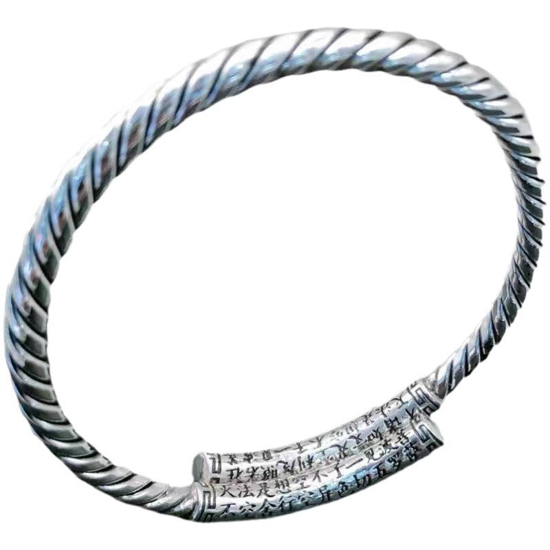 Silver tone copper bangle with twisted texture and Heart Sutra engraving