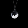 Two necklaces with black and white yin yang pendants on black cords