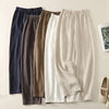 Flat lay of five pairs of cotton linen wide leg pants in various neutral colors