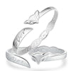 Close-up view of a silver-tone open bangle bracelet with a fox head charm