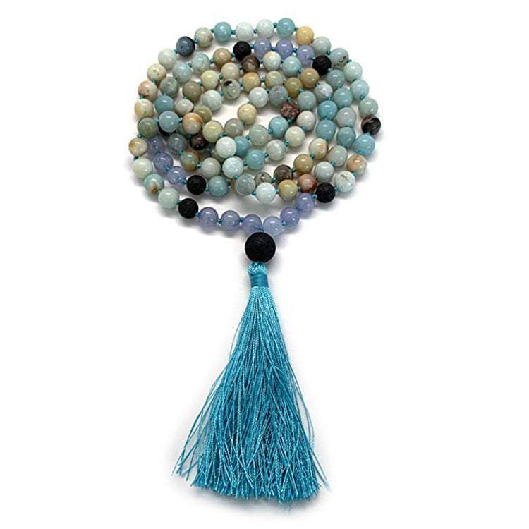 Coiled 108 bead agate mala necklace with a tassel on a white background