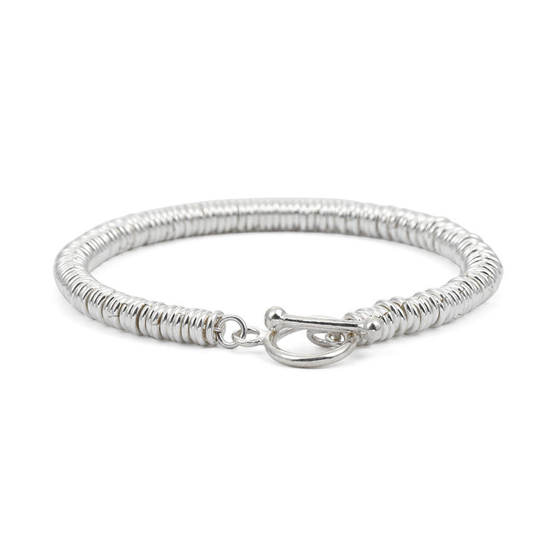 Man wearing a textured silver-tone copper chain bracelet on wrist