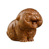 Close-up of a carved green sandalwood tiger figurine with an open mouth