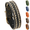Close up of a vintage style leather bracelet with cream stitching and brass buckle