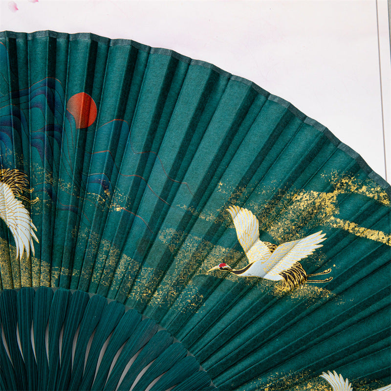 Green bamboo folding fan with white crane and cloud print