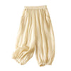 Beige cotton linen harem pants with elastic waist and pockets on white background
