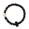 Close-up of black ebony bamboo joint bracelet with a white bead on a white background