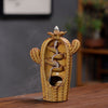 Green ceramic cactus incense burner with smoke flowing down the center