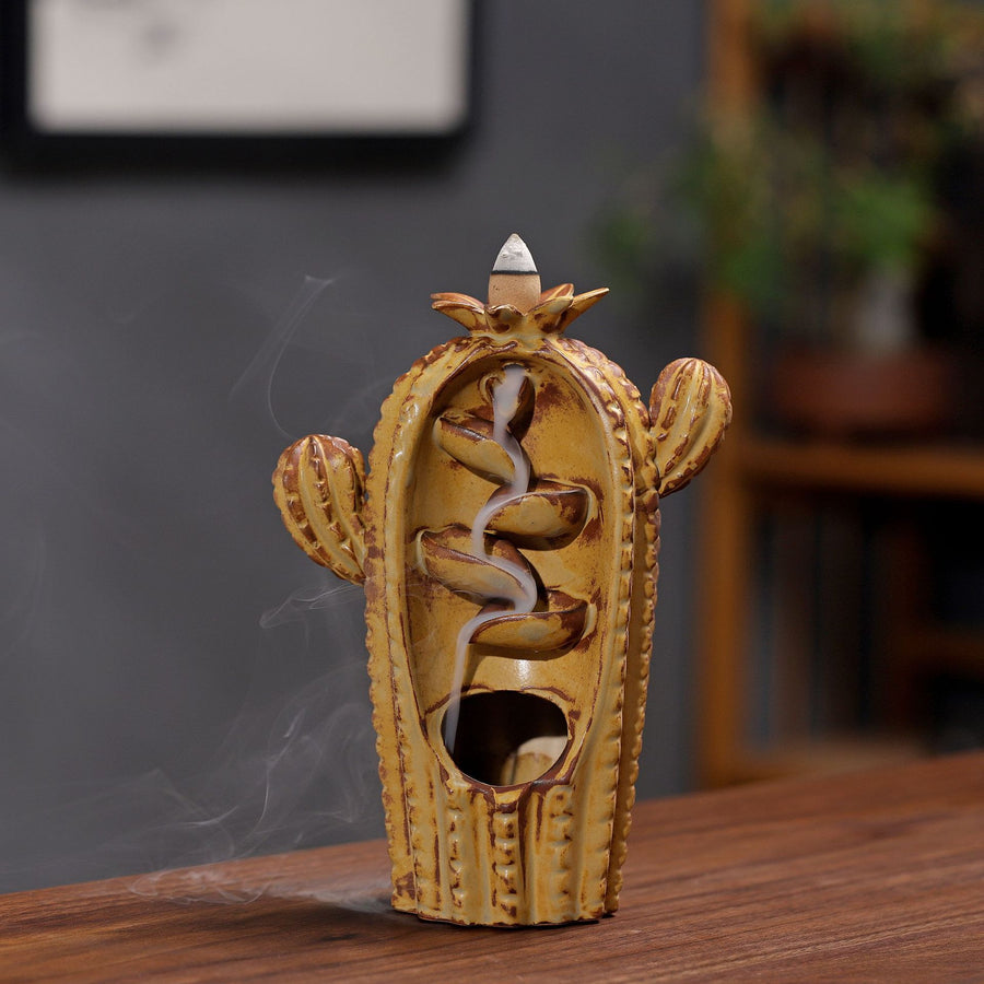 Green ceramic cactus incense burner with smoke flowing down the center