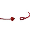 Close up of a red woven cord bracelet with a single round red cinnabar bead.