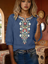Woman wearing a blue embroidered boho t-shirt with three-quarter sleeves