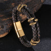 Close up of a dark brown braided leather bracelet with gold tone dragon charms